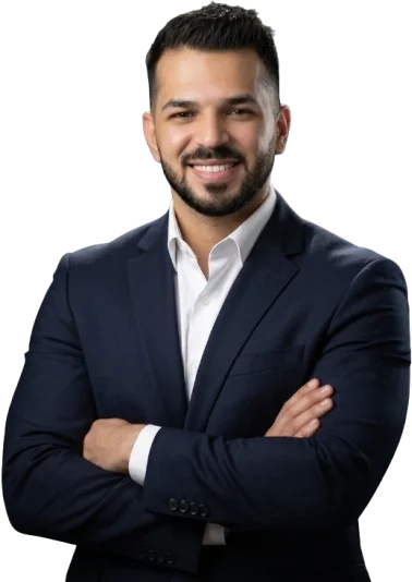 Ahmed Ibraheem, arms crossed, wearing a navy suit
